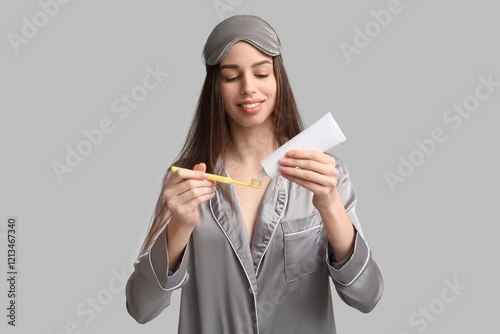 Young woman in pajamas and ...
