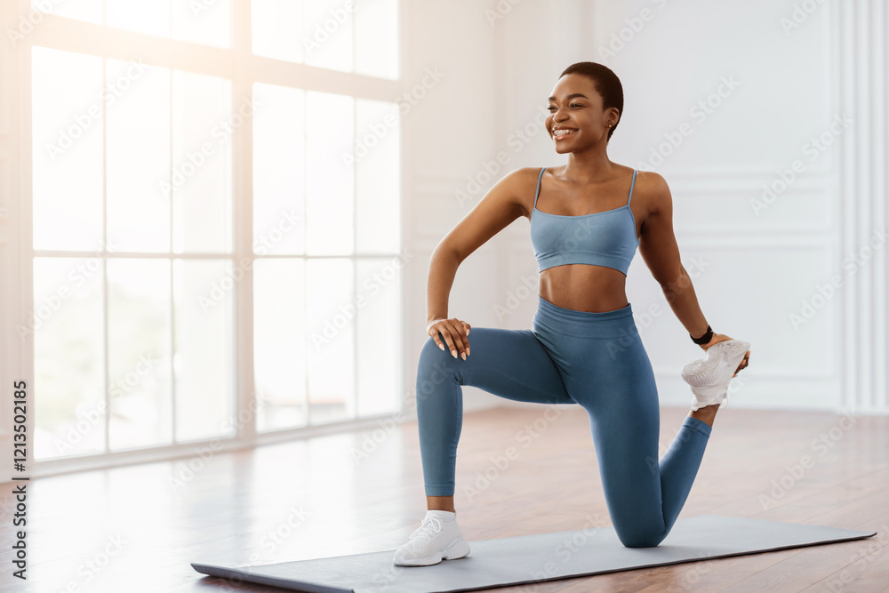 Fototapeta premium Smiling Fit African Woman Training In Living Room At Home Or At Fitness Studio, Lady Stretching Legs Doing Low Lunge With Quad Stretch, Warming Up Or Cooling Down After Exercises On Mat, Free Space