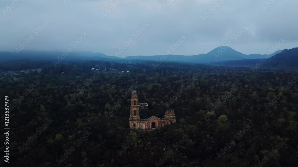 San Juan Parangaricutiro ruins surrounded by lush volcanic terrain in Michoacán, Mexico. Pan left drone aerial San Juan Parangaricutiro ruins surrounded by lush volcanic terrain in Michoacán, Mexico. Pan left drone aerial