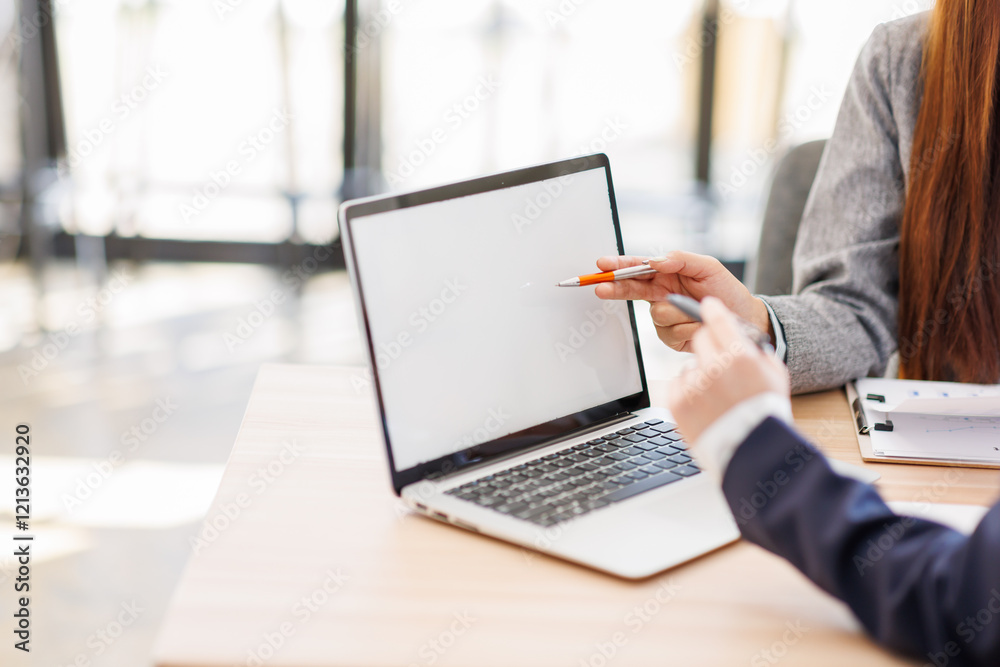 Aisan woman colleagues share their experience working in the office at a laptop. Discussion of the work plan of office workers. Aisan woman colleagues share their experience working in the office at a laptop. Discussion of the work plan of office workers.