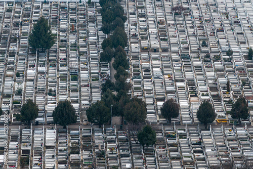 Obraz na płótnie Aerial view of a cemetery with orderly rows of graves and trees, representing remembrance and peaceful design. Cemetery concept photo. w salonie