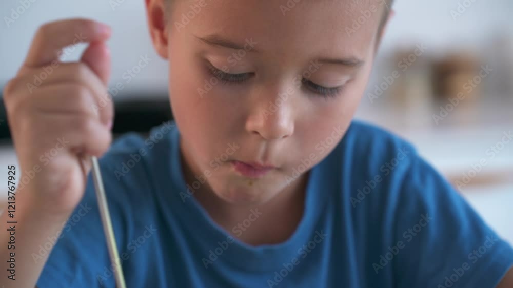 Boy Eating Chicken Noodle Soup at Home in a Modern Kitchen Boy Eating Chicken Noodle Soup at Home in a Modern Kitchen
