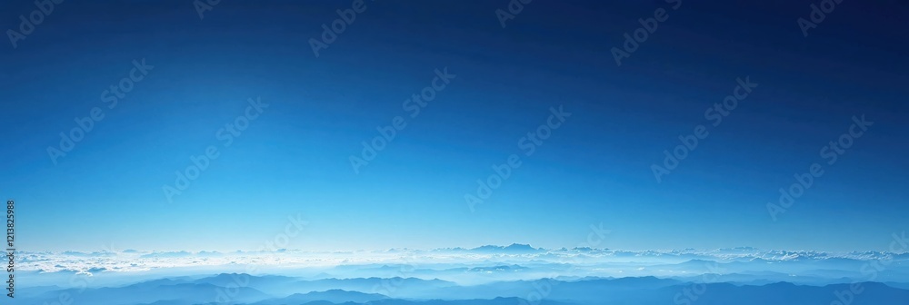 Fototapeta premium Aerial view of blue sky and mountain range with clouds in a clear day from above