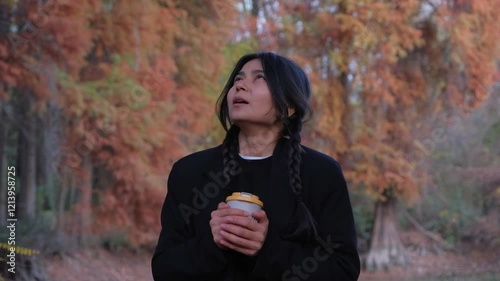 Woman enjoys her coffee, blending modern elegance with a peaceful outdoor vibe.