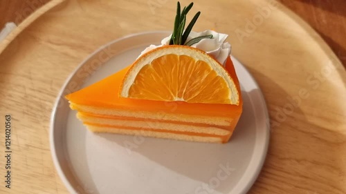 Slices of orange cake on a rotating plate, served as a dessert in a café on a holiday