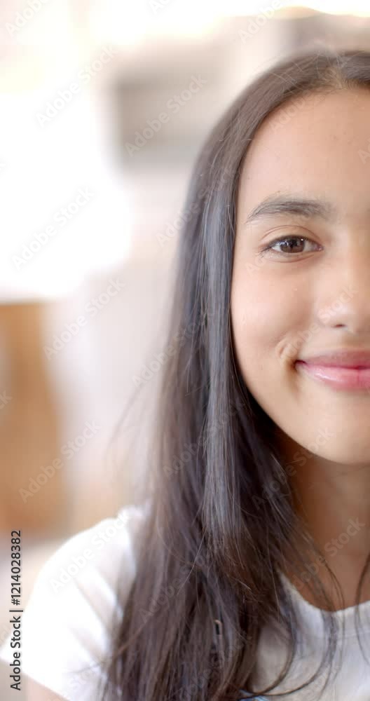 Vertical video: Smiling teenage girl with long hair enjoying time with friends indoors Vertical video: Smiling teenage girl with long hair enjoying time with friends indoors