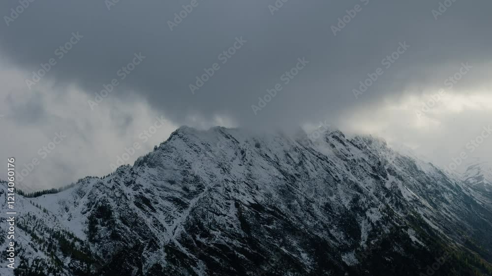 Snow-dusted rocky cliffs rising against a backdrop of misty, snow-covered mountains.
Snow-dusted rocky cliffs rising against a backdrop of misty, snow-covered mountains.