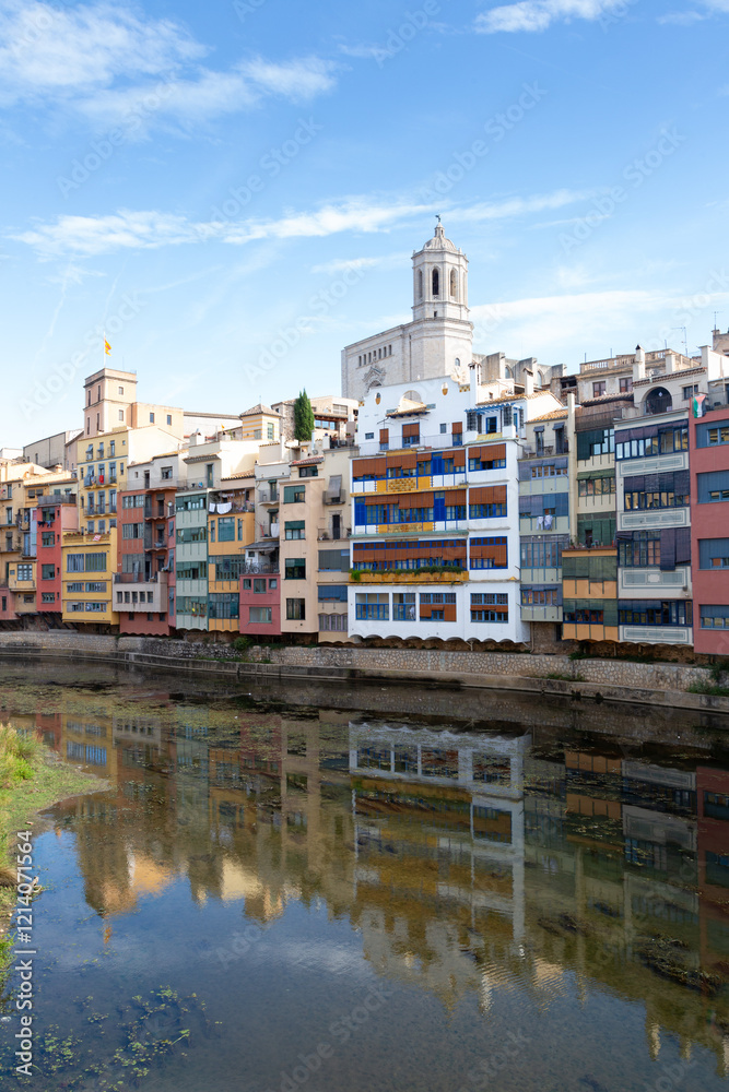 Colorful houses reflecting in the onyar river in girona, catalonia