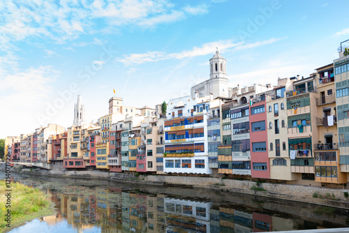 Colorful houses reflecting in the onyar river in girona, catalonia photo