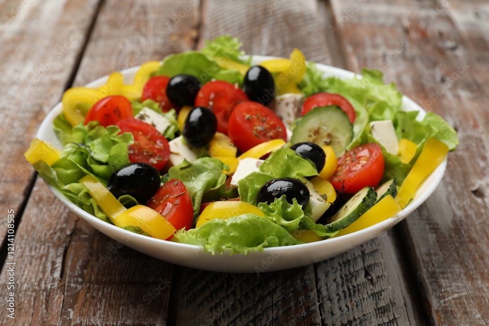 Delicious fresh Greek salad on wooden table, closeup Delicious fresh Greek salad on wooden table, closeup