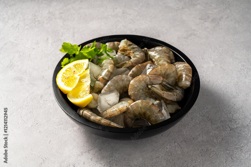Raw Shrimps prawns and ice cubes with lemons Raw Shrimps prawns and ice cubes with lemons