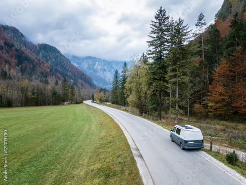 Amazing autumn view of the picturesque Logar Valley (Logarska Dolina) and a small camper moving along the Solcava panoramic road, Slovenia photo