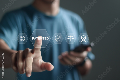 Patented patent copyright law business technology concept. Person touch patented text with copyright icons for author rights and patented intellectual property.