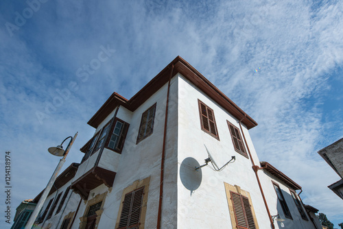 View of a narrow street in the historical center of Nicosia, Cyprus. Old historical houses and buildings in Nicosia. Historical buildings made of wood and stone on the streets of Cyprus.	 photo