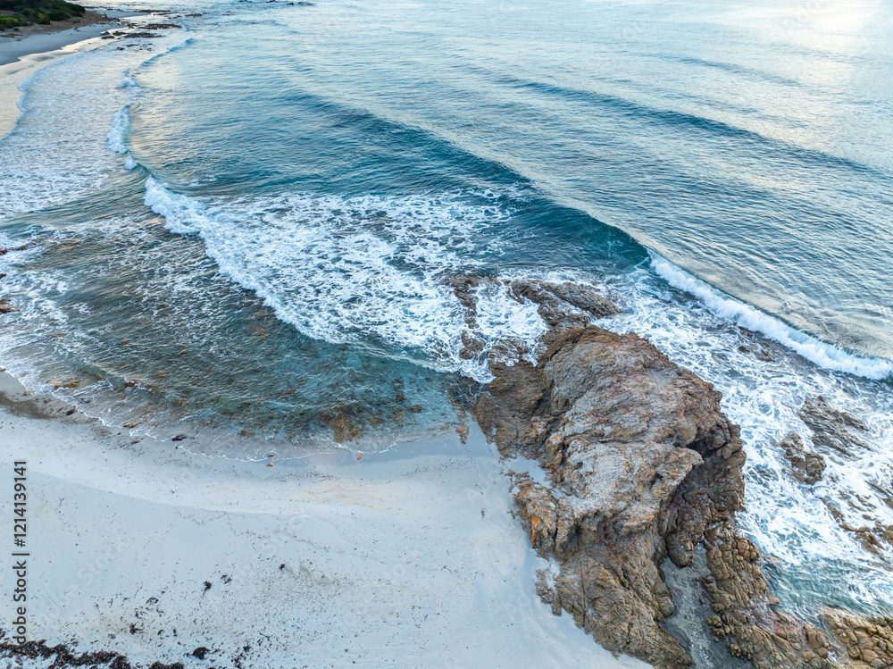 Aerial view ocean waves on remote and wild sandy beach in Italy. Background texture of water, waves and beach.