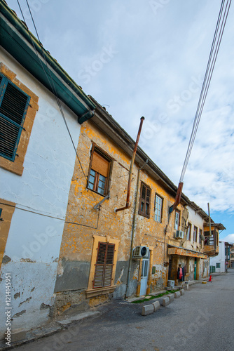 Fototapeta Naklejka Na Ścianę i Meble -  View of a narrow street in the historical center of Nicosia, Cyprus. Old historical houses and buildings in Nicosia. Historical buildings made of wood and stone on the streets of Cyprus.	