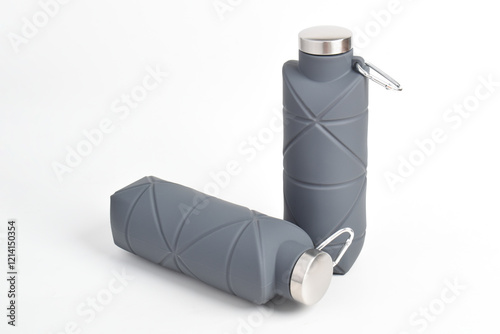 Gray color foldable silicone drinking bottle isolated on white background. Eco-friendly reusable mug