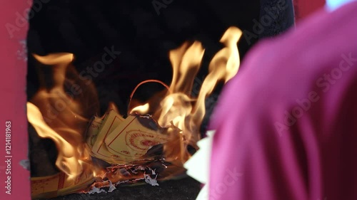 Close up shot of burning fake silver and gold bills for the ancestors. Paper money also burnt at celebration of Chinese New Year. photo