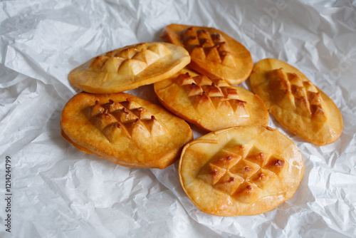 Polish traditional smoked cheese oscypek in white cooking paper photo