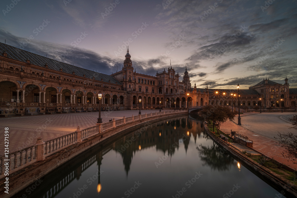 Naklejka premium Plaza de Espana, Seville, Andalusia, Spain, at sunrise. The building is reflecting in the calm, smooth water.
