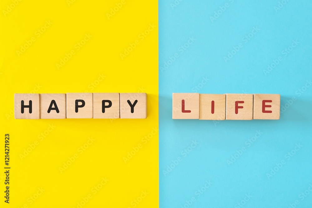 Happy life reminder wooden blocks typography in bright blue and yellow background.