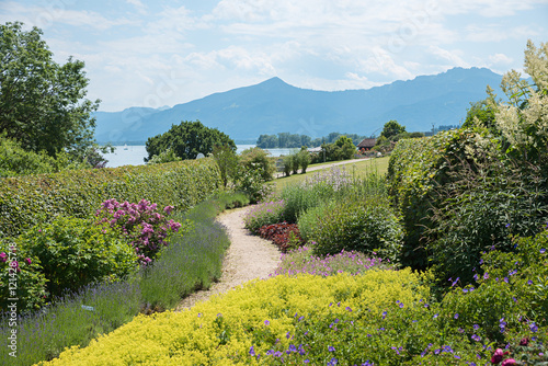 beautiful park landscape at tourist resort Gstadt, with view to lake Chiemsee and mountains photo