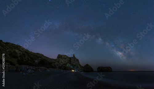 Starry Night Sky with Milky Way over Coastal Rock Formation