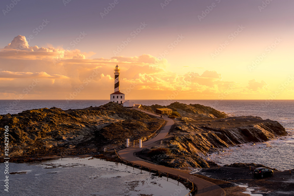 Tranquil Coastal Morning, Faro de Favaritx, Menorca. Lighthouse glowing under soft dawn light with vibrant skies and a peaceful seascape