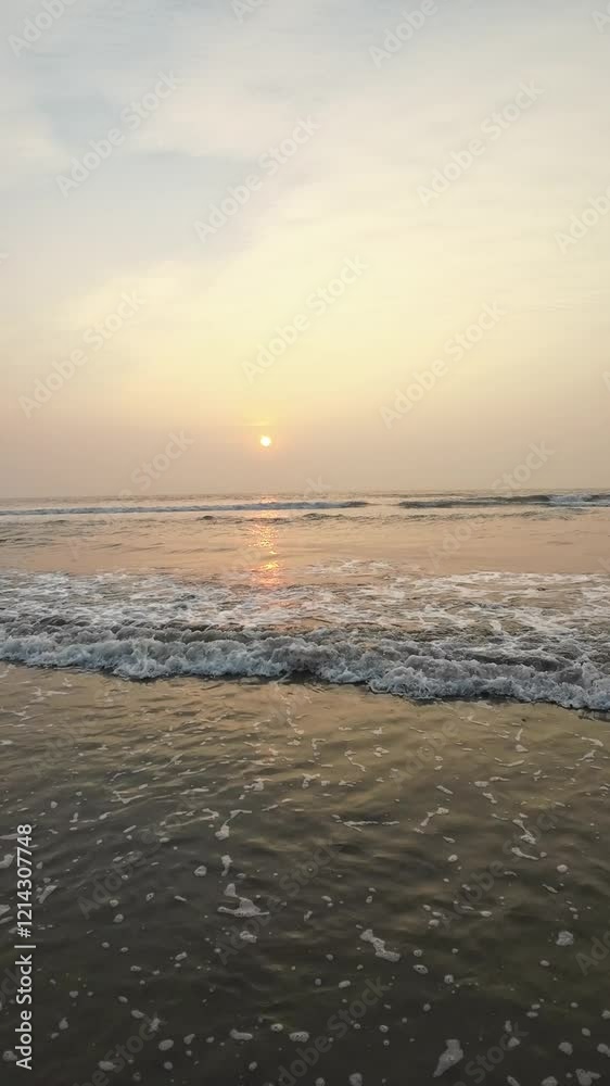 Beautiful Foggy Sunset On Beach With Rolling Waves And Black Sand People
