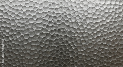 Hammered Metal Texture: Close-up of a hammered metal surface revealing a textured pattern of raised and indented shapes creating a unique, abstract design.