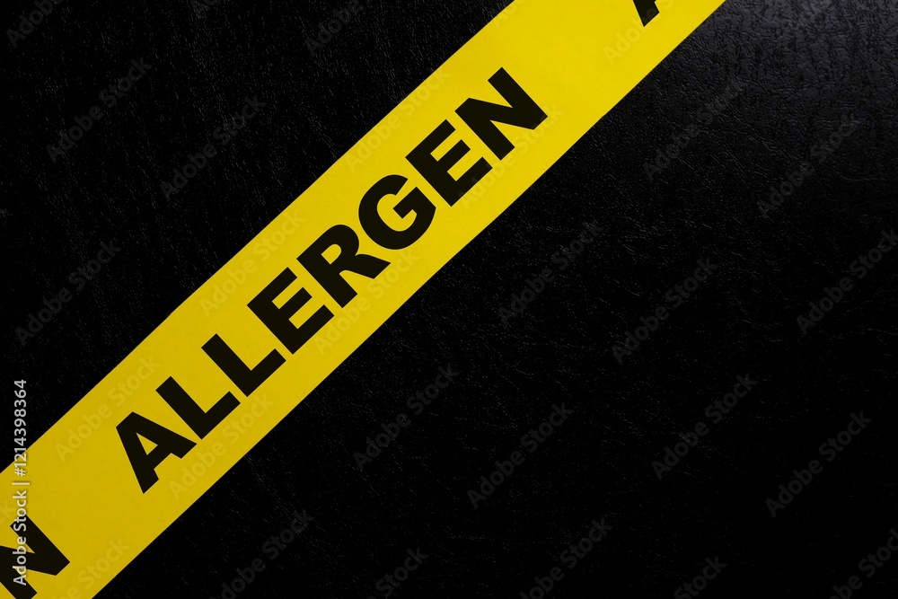Food allergen content caution and warning concept. Yellow barricade tape with word in dark black background.