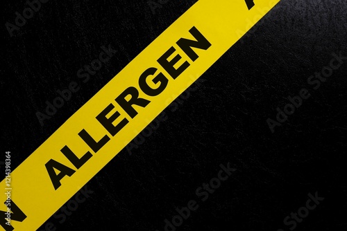 Obraz na płótnie Food allergen content caution and warning concept. Yellow barricade tape with word in dark black background. w salonie