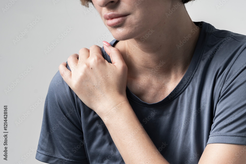Close-up portrait of young woman suffering from shoulder pain Close-up portrait of young woman suffering from shoulder pain