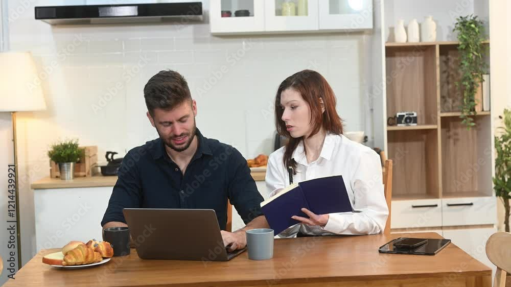 Modern couple collaborating over coffee in a cozy kitchen setting with a laptop, notebook, and breakfast.