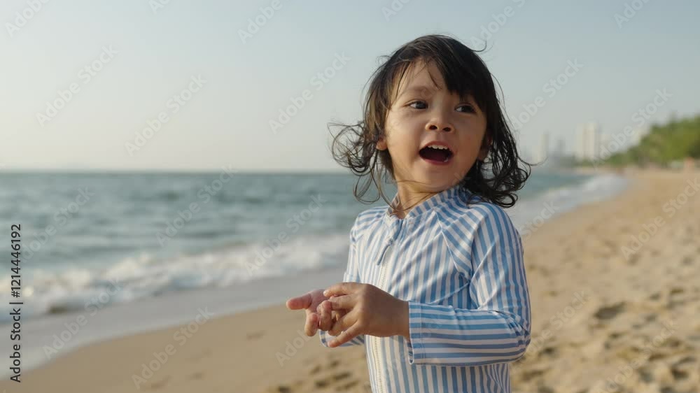 slow motion of cheerful toddler baby girl laughing on the sea beach in Pattaya, Thailand slow motion of cheerful toddler baby girl laughing on the sea beach in Pattaya, Thailand