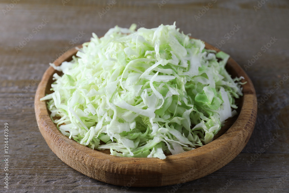 Fresh shredded cabbage on wooden table, closeup Fresh shredded cabbage on wooden table, closeup