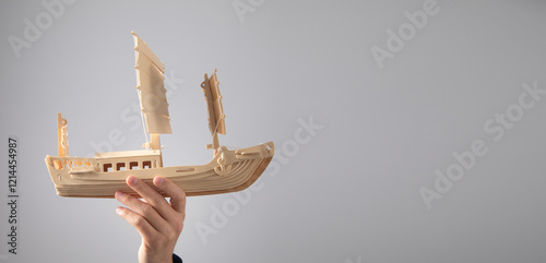 Fotografi Man showing wooden boat. Business