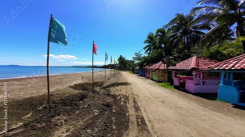 Discover the sun-kissed shores of Bacuag, Surigao Del Norte, where golden sands meet beach huts framed by vibrant tropical palm trees. Perfect for summer vacations