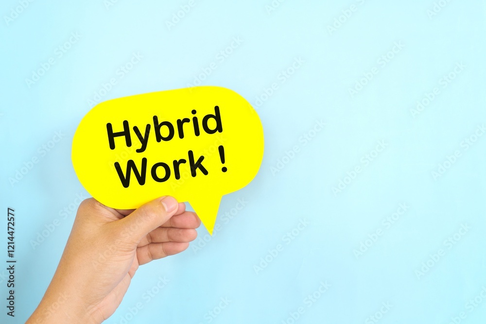 Human hand holding yellow speech bubble with written phrase Hybrid Work. Hiring for hybrid work setup.