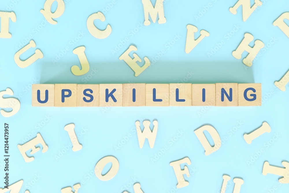 Word upskilling spelled in wooden blocks letters. Upskilling in workplace.