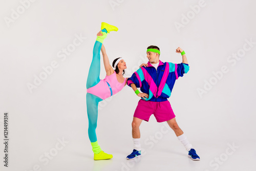 Dynamic retro-inspired couple showcases aerobics style, exuding energy and joy in colorful activewear against a clean white background photo