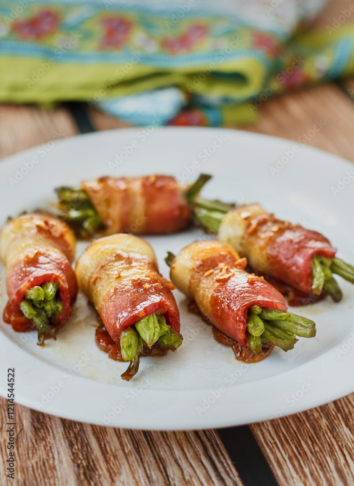 bacon wrapped green beans served on a plate with a green napkin bacon wrapped green beans served on a plate with a green napkin