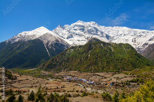 View of Annapurna II and IV mountains in Himalayas from Upper Pisang, Annapurna Conservation Area, Nepal. Snow capped landscape. Annapurna face. Annapurna Circuit Trek. Hiking trekking concept. 