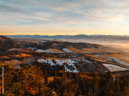 Sunset over Liptov region in the backround with Liptovska mara lake and Tatras mountains around. Liptovsky mikulas landspace, slovakia. photo