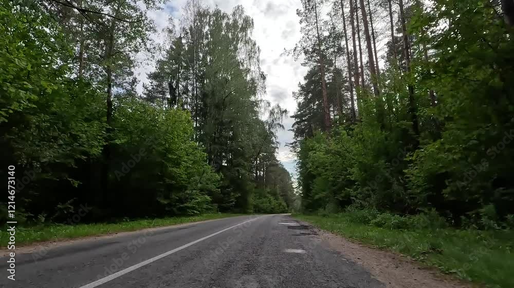 Highways, roadside and road line markings. The car drives along the road on a summer day. Highways, roadside and road line markings. The car drives along the road on a summer day.