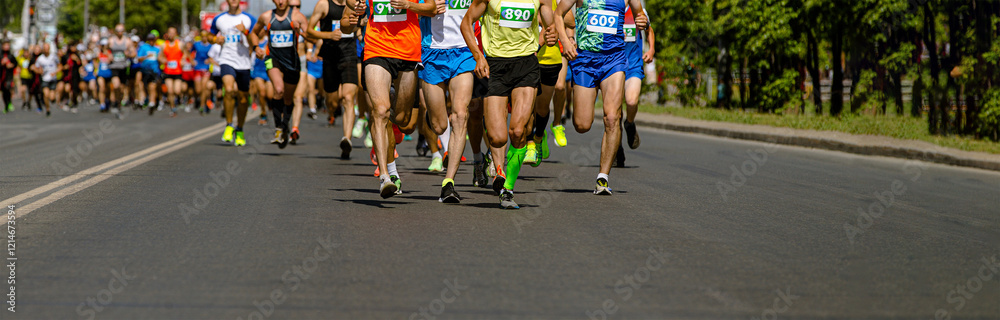 athletes race down road in colorful running gear, showcasing determination and speed in marathon event athletes race down road in colorful running gear, showcasing determination and speed in marathon event