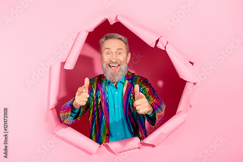 Colorful senior man breaking pink background in vibrant suit embracing fun and eccentricity