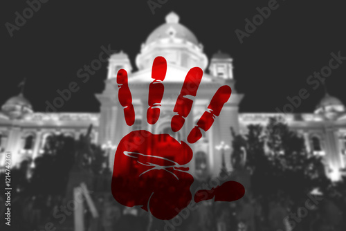 A red handprint with National Assembly in background, Belgrade, Serbia. antigovernment protests photo