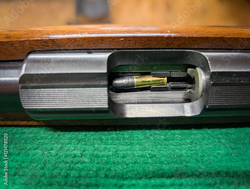 A small caliber rifle with a cartridge in the magazine, close-up, at a shooting range. photo