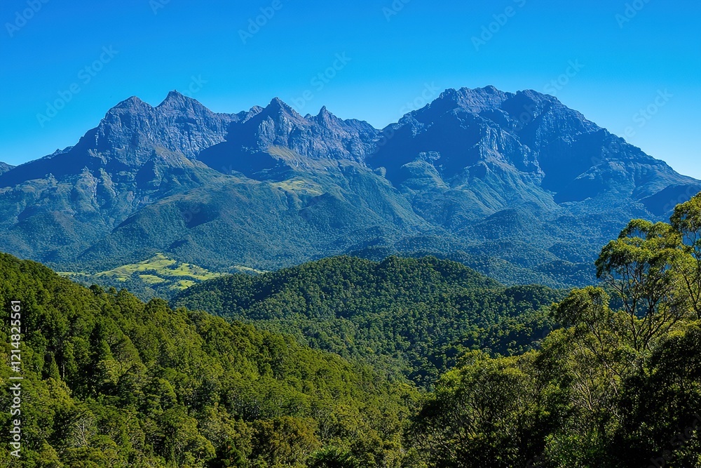 Fototapeta premium Majestic mountain range under a clear blue sky